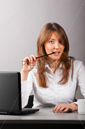 business woman is sitting in the office with laptop and flirting