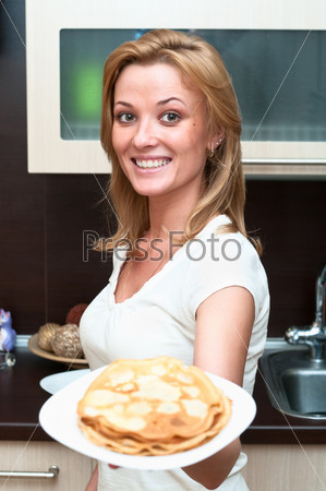 Beautiful happy smiling woman in kitchen interior. One person only