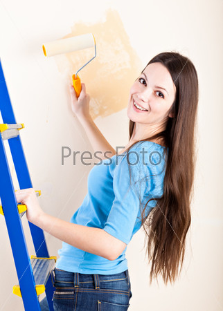 A woman is painting walls