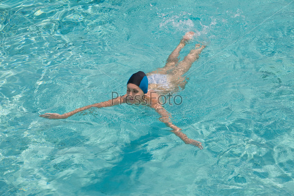 The sports girl swims in pool