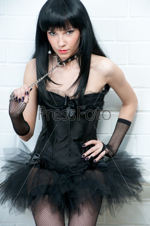 Naughty young woman in corset and collar, sadomaso style