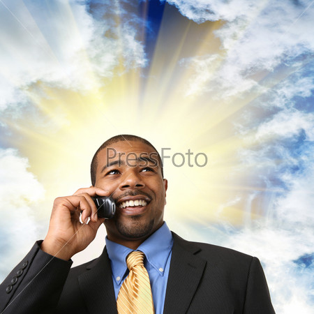 African American businessman talking on mobile phone, smiling. Close-up, isolated over white.
