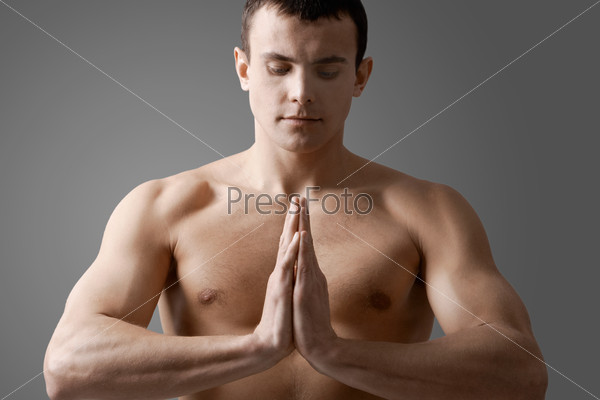 Image of handsome man with bare torso meditating, stock photo