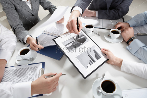 Image of human hands during discussion of business plans