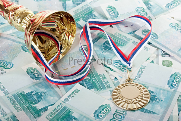 Payment sporting achievements. Cup, gold medal and Russian money.