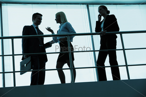 Three outlines of business partners interacting in office