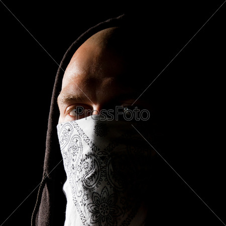 Portrait of a thug in mask at night