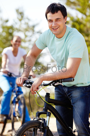 Portrait of a handsome man by his bike