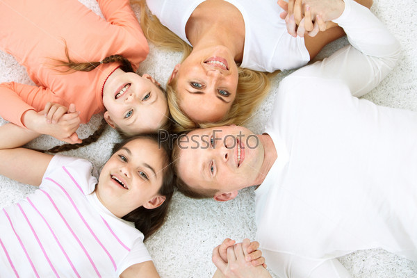Portrait of cheerful family in casual clothes looking at camera