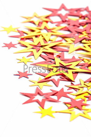 Yellow and red stars confetti on a white background