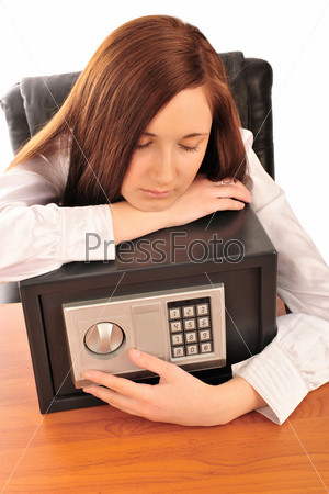 Closeup portrait of young pretty woman at her desk with deposit safe