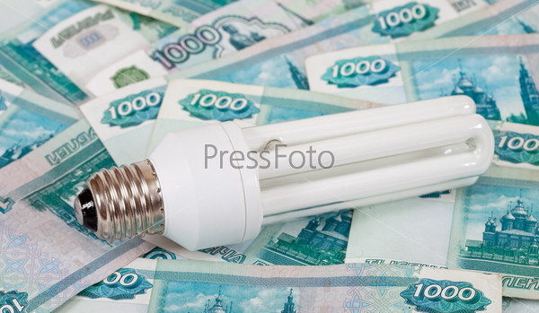 Energy saving lamp against the money