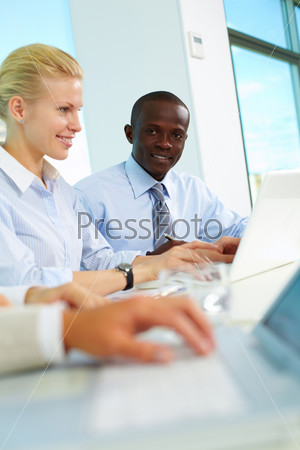 Vertical image of businessman looking at camera while planning work in working environment