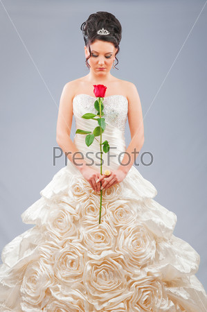 Beautiful bride with rose in studio shooting