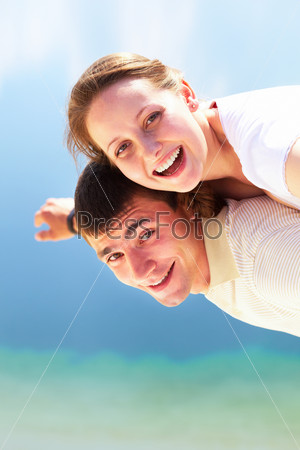 Photo of happy girl and her boyfriend having fun in summer