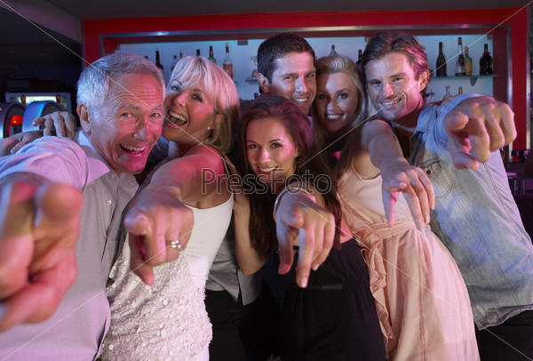 Group Of People Having Fun In Busy Bar