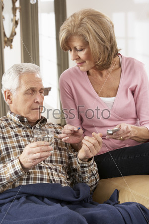 Senior Woman Caring For Sick Husband