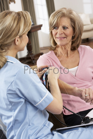 Health Visitor Taking Senior Woman\'s Blood Pressure