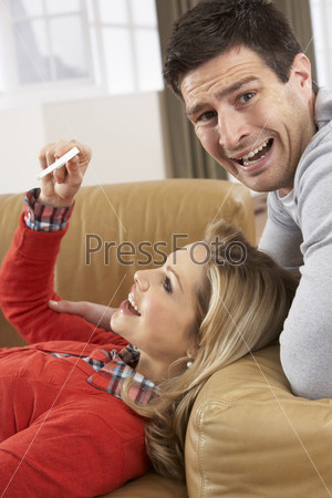 Couple Looking At Result Of Home Pregnancy Test Kit