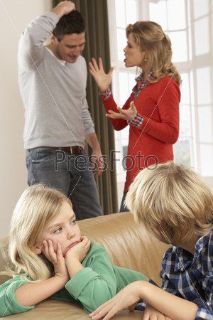 Parents Having Argument At Home In Front Of Children