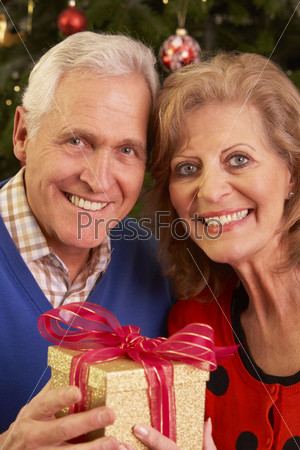 Senior Couple Exchanging Christmas Gifts