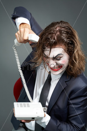 Portrait of furious businessman with theatrical makeup ringing off