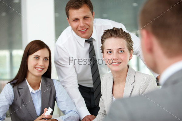 A woman manager looking at business partner during conversation