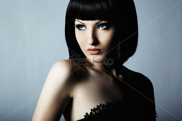 Fashion portrait of a young beautiful dark-haired woman