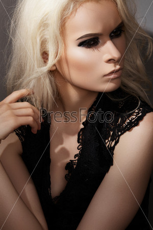 Luxury & chic beauty. Sexy beautiful blond woman model in lacy black dress, with dark gloss make-up. Elegant fashion and glamour style