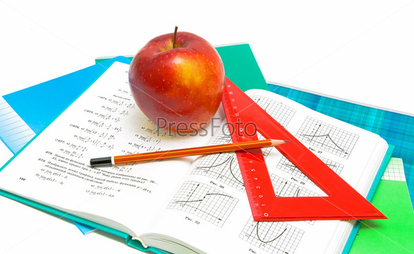 apple, book and ruler closeup on white background