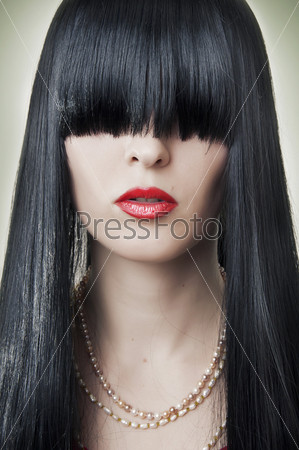 Portrait of female face with creative hairstyle - long black hair. Fashion makeup - classic red lips.