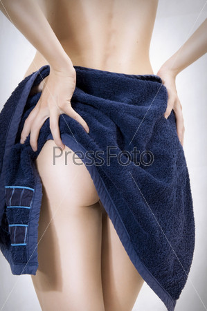 Sexual female body. Woman taking a dark blue towel