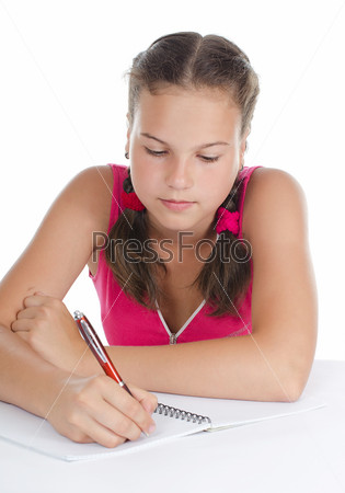 The young girl writes to writing-books isolated
