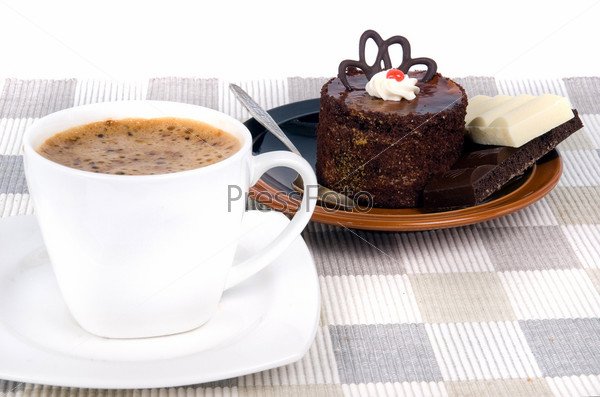 coffee with cake on textile mat