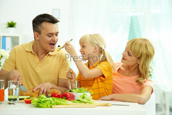 Portrait of happy family having breakfast in the morning in the kitchen