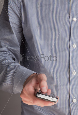 the guy is typing a message on a cell phone