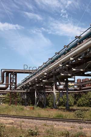 Industrial gas and oil pipelines on metal in a metallurgical plant. Constru
