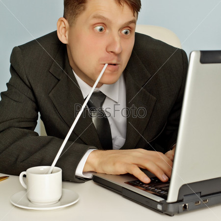 Funny businessman drinking coffee and working