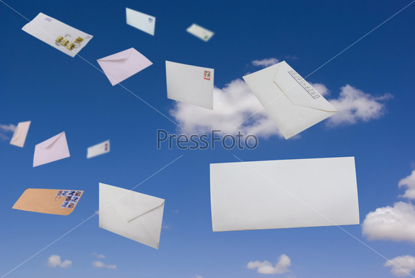 Envelopes flying against the blue sky and clouds