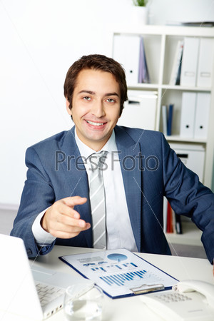 Portrait of a successful employer looking and pointing at camera
