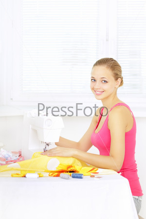 girl using sewing machine to sew clothing