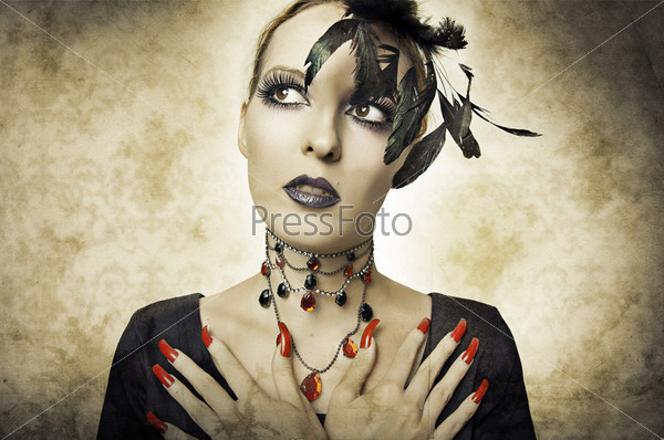 Glamour portrait in retro style of beauty young woman in black dress with long red finger nails, necklace and dark make up. Closeup sexy model face. Costume for halloween
