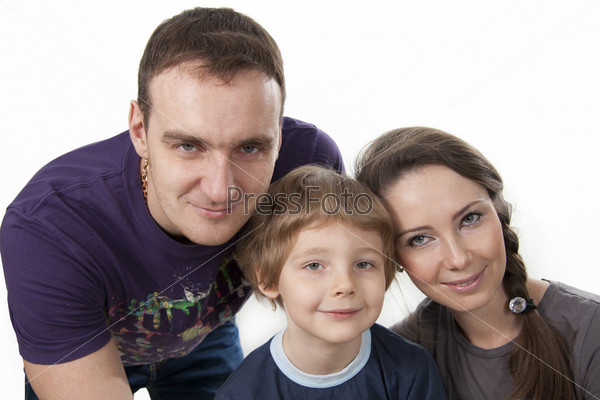 Young European family from three persons - mother, father and\
son.