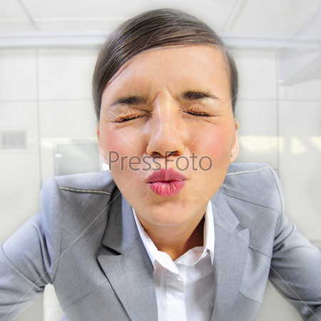 Closeup portrait of cute young business woman smiling and flirting sending air kiss