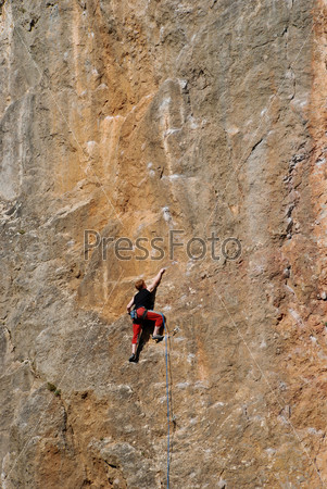 Extreme sport. The rock-climber during rock conquest