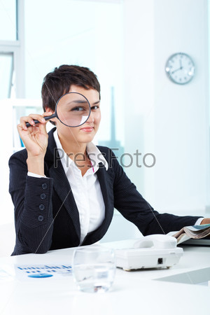 Photo of pretty businesswoman looking at camera through spy glass