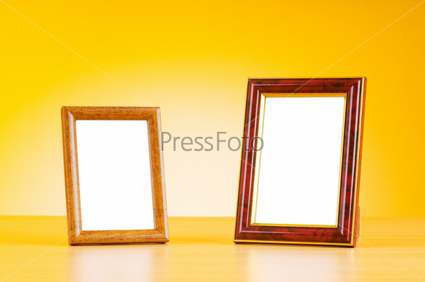 Wooden picture frames on the gradient background, stock photo