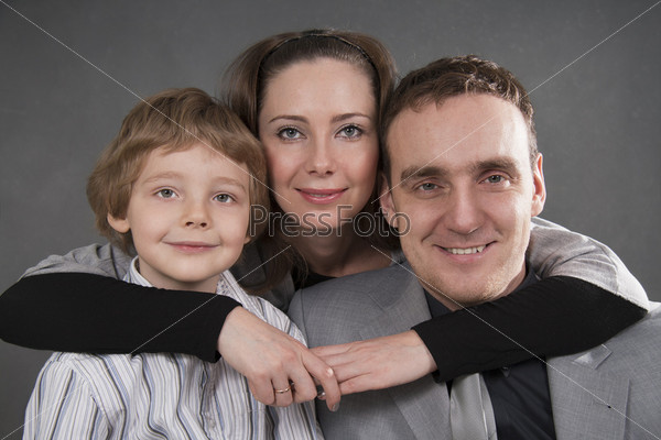 Young European family from three persons - mother, father and son.