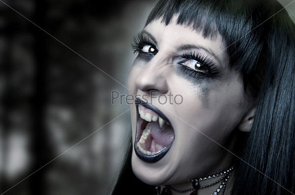 Halloween horror concept. Dark portrait of Night mystic woman vampire