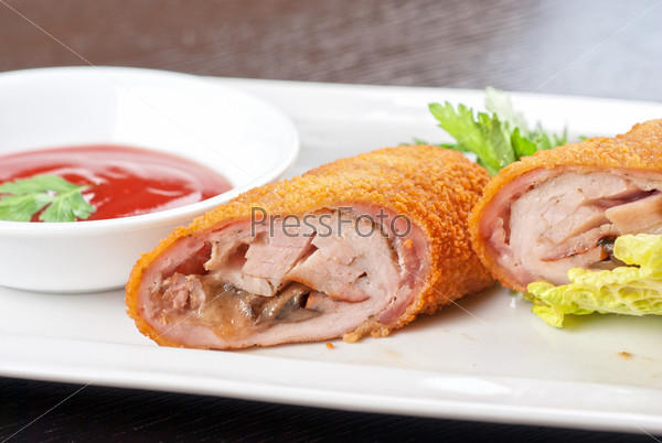Closeup of rolls from pork meat, champignon mushroom, cheese and sauce, stock photo